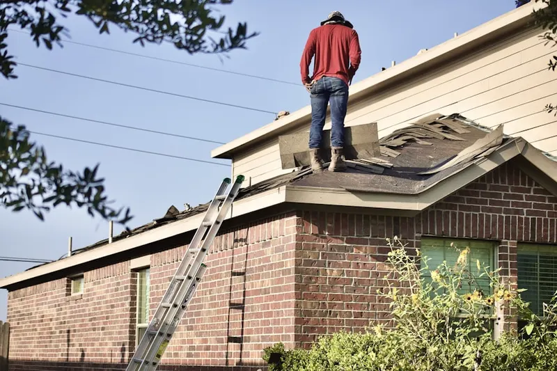 Professional roofer working on a residential roof in West Central Loveland